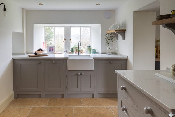 Light grey shaker kitchen with white stone worktops by Olive & Barr
